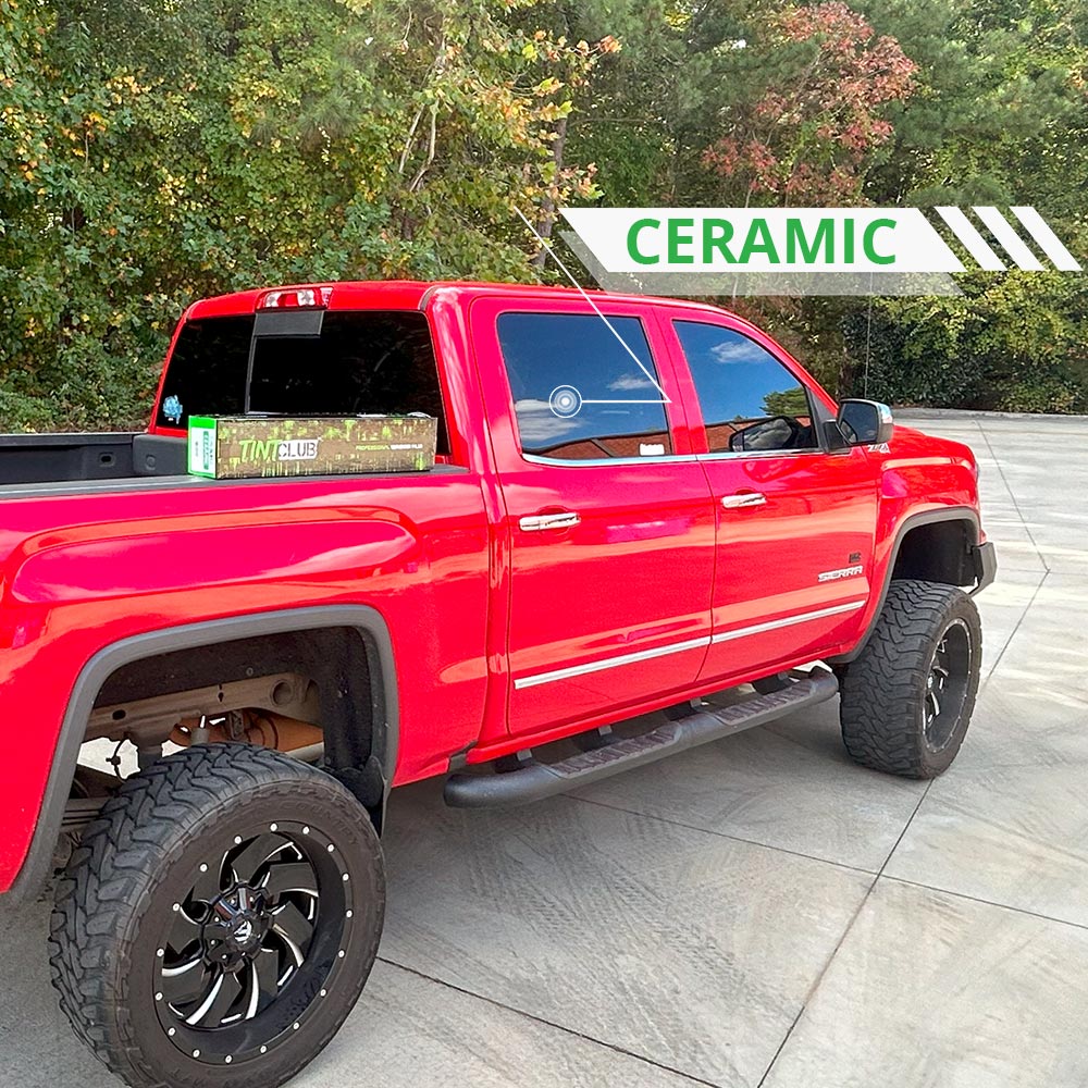 Red GMC truck with ceramic window tint on side windows